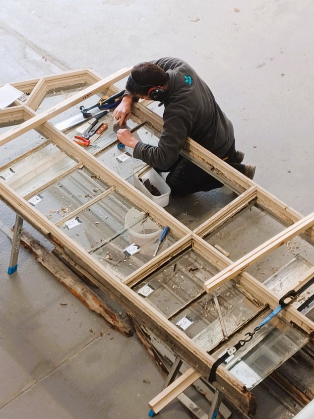 Specialist carpenter working on a window frame restoration